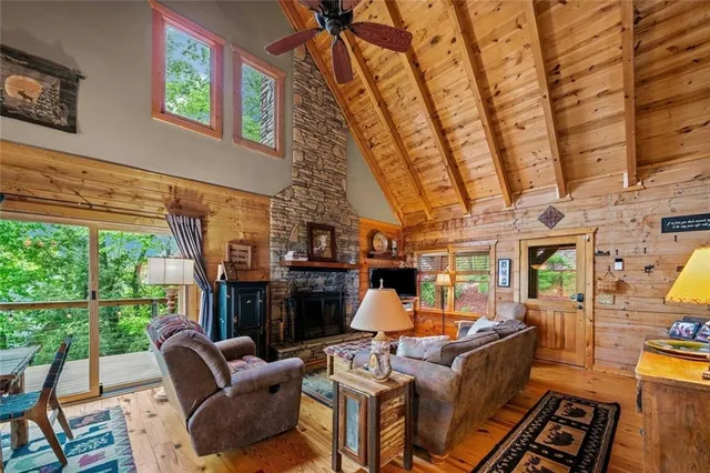 a living room with furniture a fireplace and a floor to ceiling window