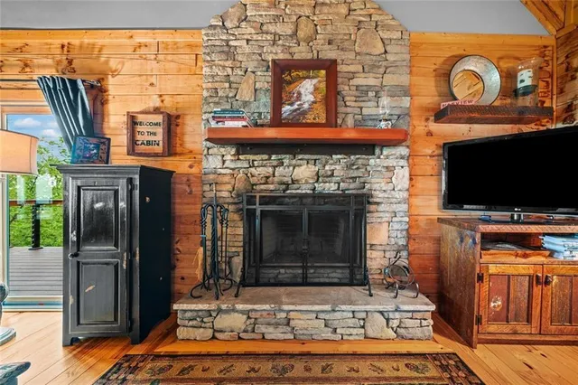 a living room with fireplace furniture and a flat screen tv
