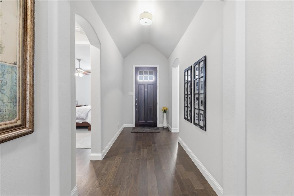 9708 Surveyor Road Oak Point, TX 75068 - Photo 3 of 34 Foyer featuring dark wood-finish flooring, light grey walls, and a recessed ceiling with an overhead light fixture