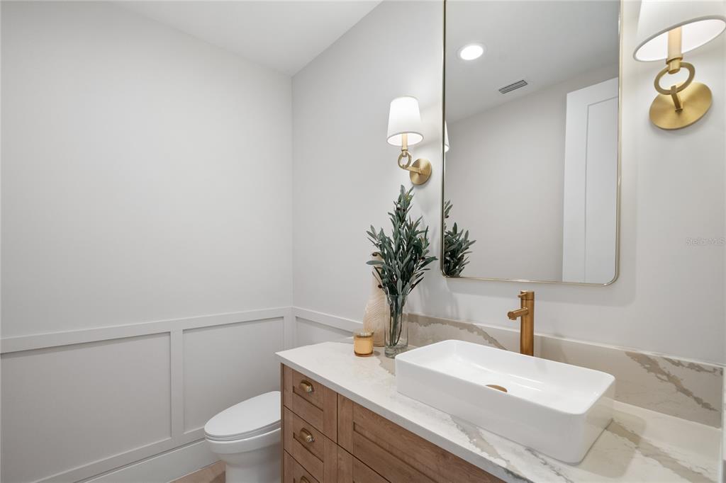 1751 Glencoe Road Winter Park, FL 32789 - Photo 21 of 45 a bathroom with a granite countertop sink a toilet and mirror
