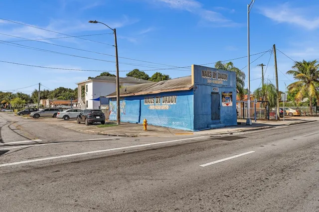a street sign on a sidewalk next to a road