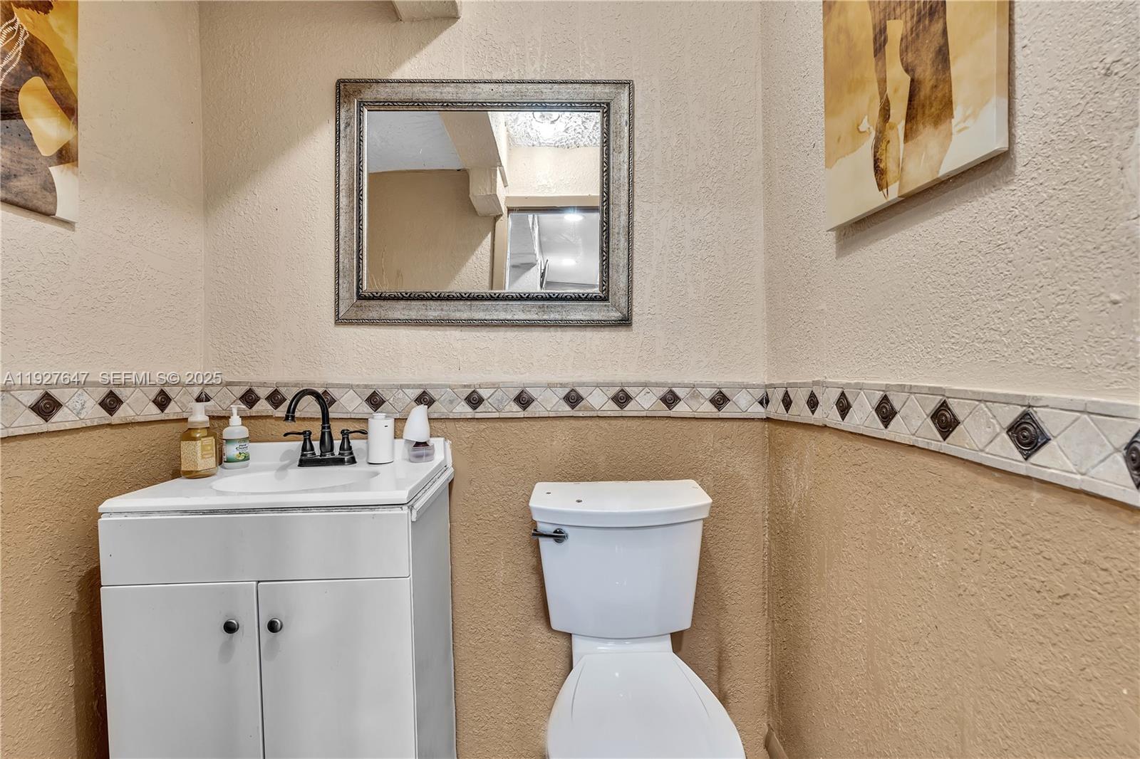 4500 Northwest 12th Avenue Miami, FL 33142 - Photo 14 of 16 a bathroom with a sink mirror and toilet