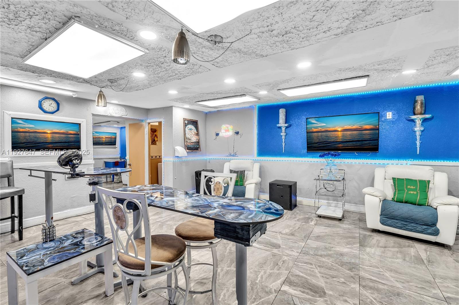 4500 Northwest 12th Avenue Miami, FL 33142 - Photo 15 of 16 a kitchen with stainless steel appliances granite countertop a stove a sink dishwasher a dining table and chairs with wooden floor