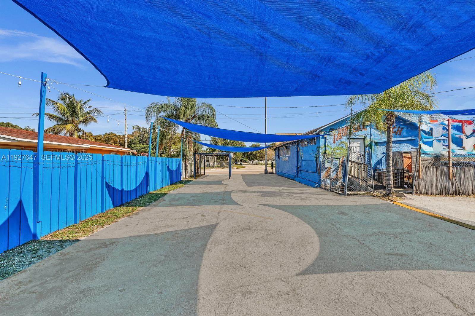 4500 Northwest 12th Avenue Miami, FL 33142 - Photo 4 of 16 a view of a patio with table and chairs under an umbrella