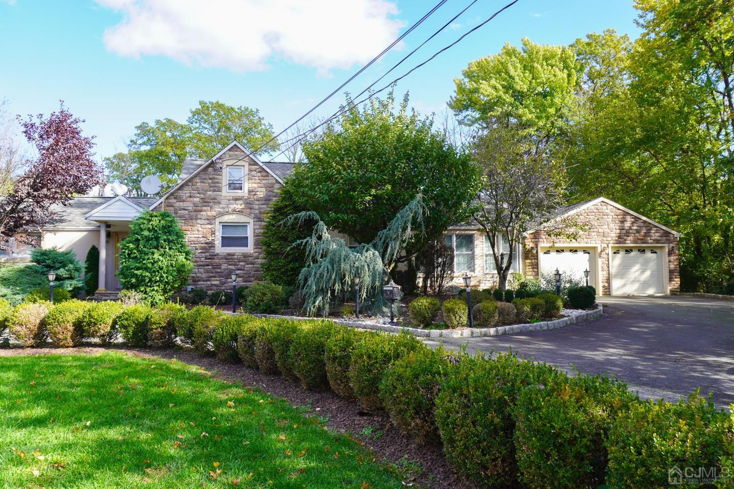 a view of a house with a yard and potted plants
