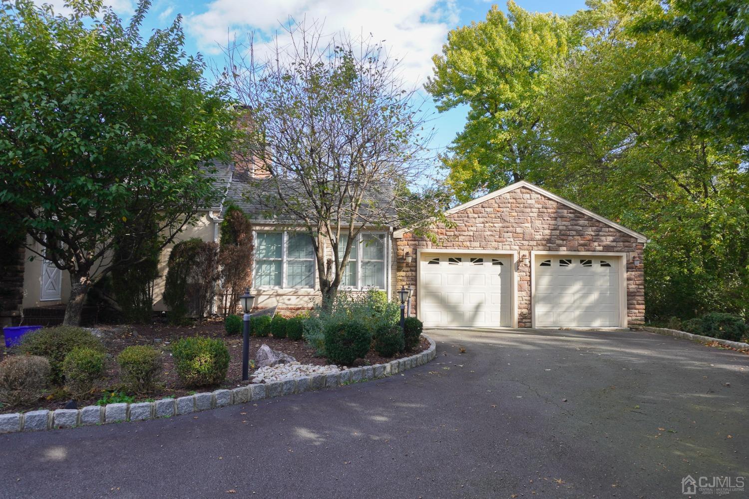 140 Meredith Road Colonia, NJ 07067 - Photo 2 of 30 a front view of a house with a yard and garage