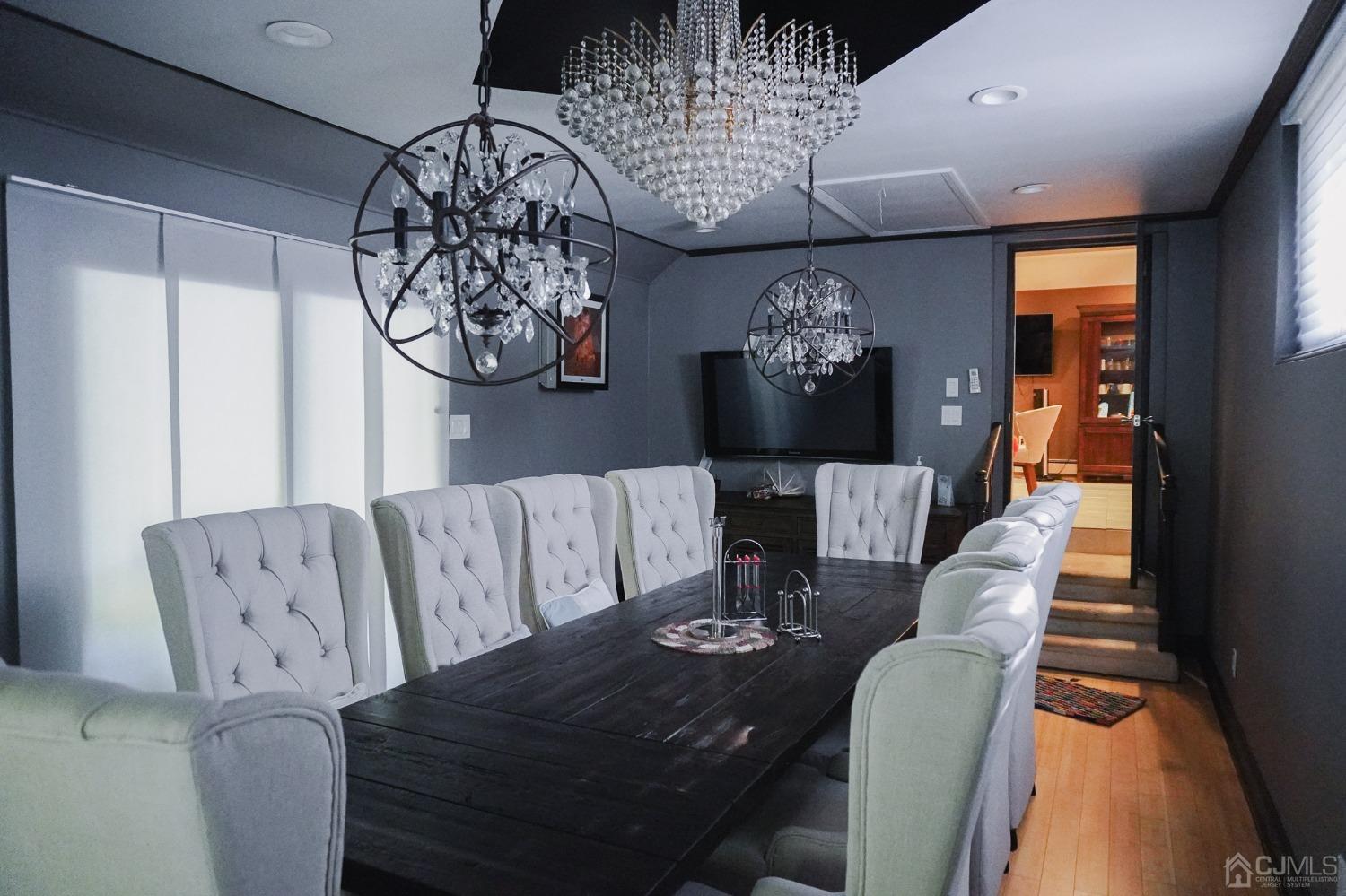 140 Meredith Road Colonia, NJ 07067 - Photo 25 of 30 a living room with furniture a chandelier and a dining table