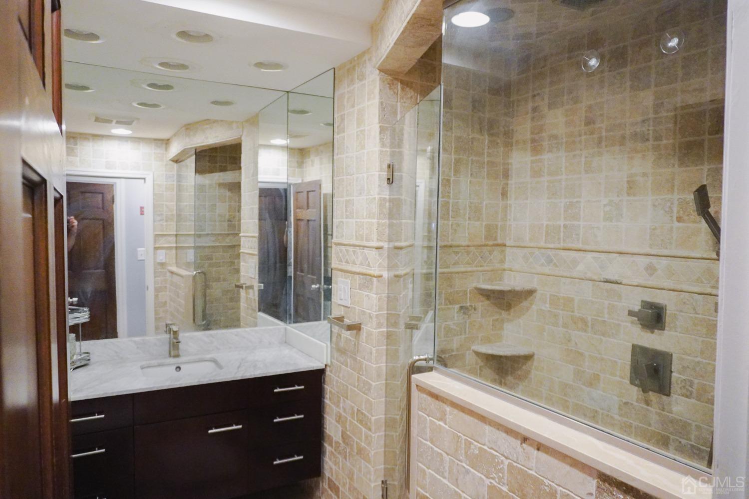 140 Meredith Road Colonia, NJ 07067 - Photo 26 of 30 a bathroom with a granite countertop sink a mirror and shower