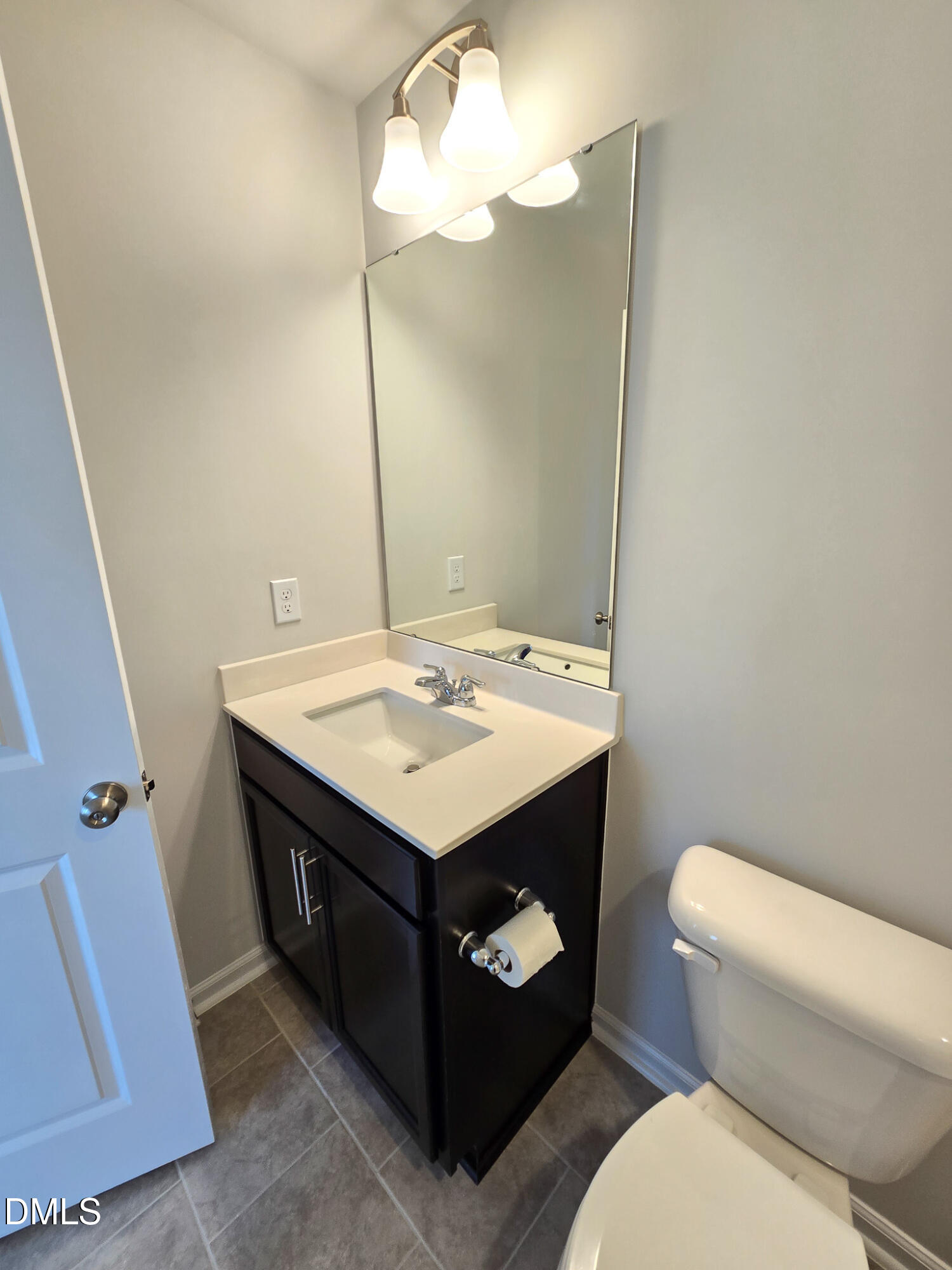 2431 Kasota Lane Raleigh, NC 27610 - Photo 44 of 46 a bathroom with a sink a toilet and a mirror