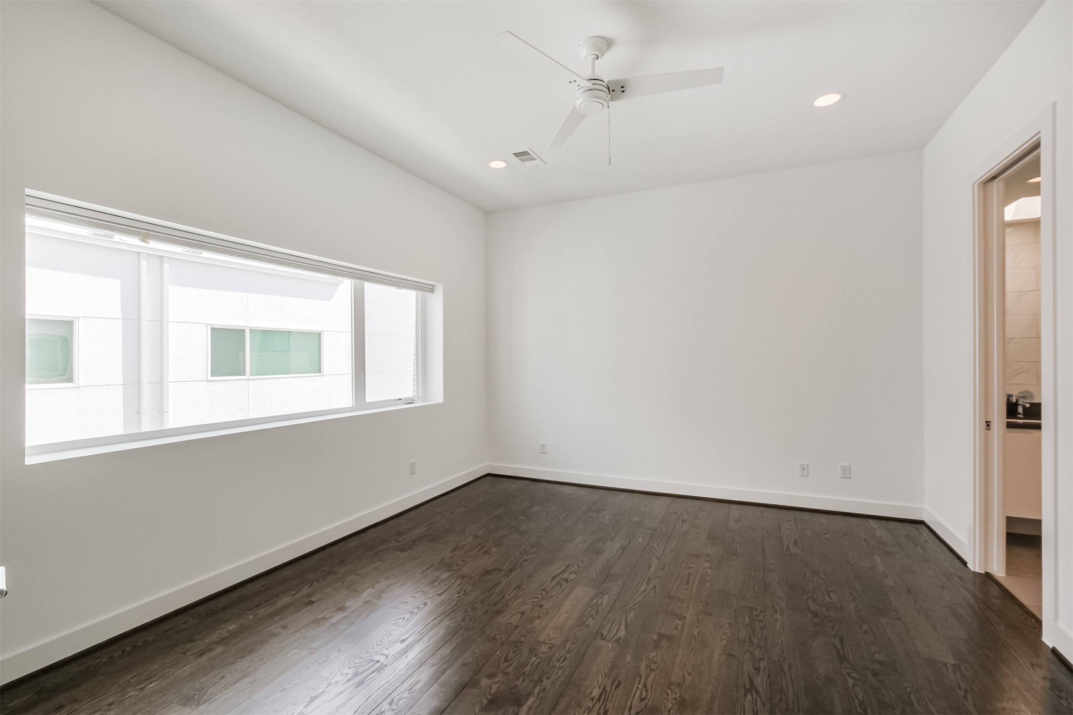 1157 West 18th Street Houston, TX 77008 - Photo 23 of 41 an empty room with wooden floor and windows