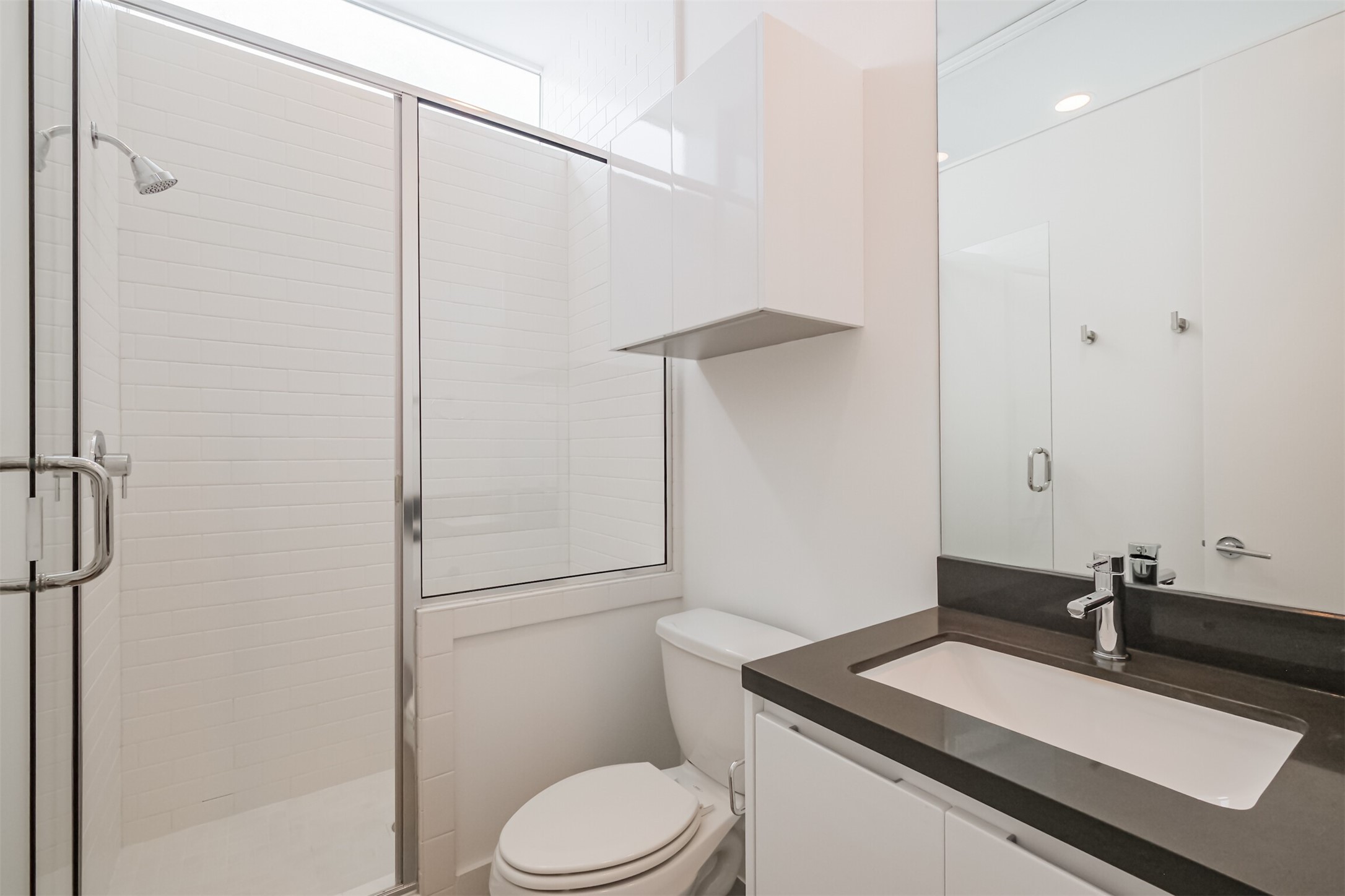 1157 West 18th Street Houston, TX 77008 - Photo 34 of 41 a bathroom with a sink toilet vanity and shower