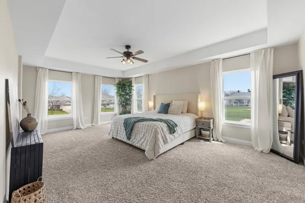 a bed room with a bed and a chair