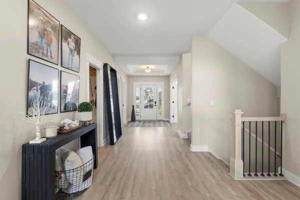 a living room with furniture a fireplace a flat screen tv and potted plant