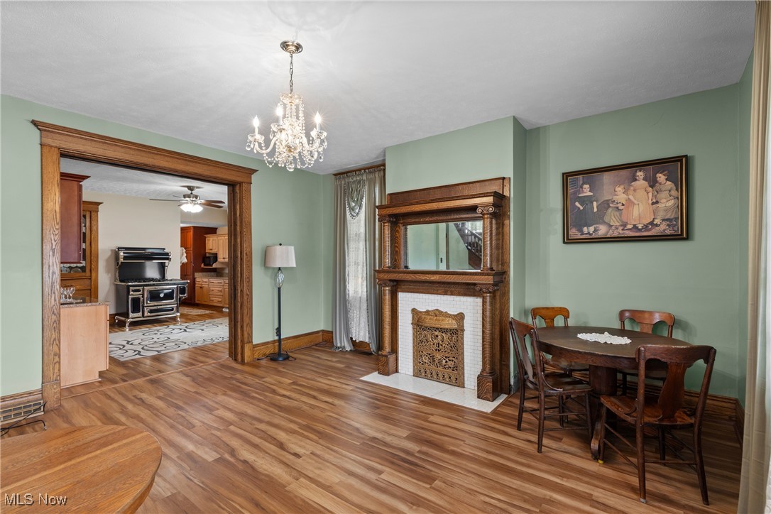 1011 Parriott Avenue Moundsville, WV 26041 - Photo 6 of 44 Dining space with a chandelier, wood finished floors, and a ceiling fan