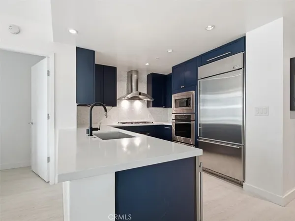a kitchen with stainless steel appliances a refrigerator and a sink