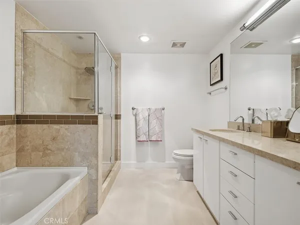 a bathroom with a double vanity sink toilet and shower