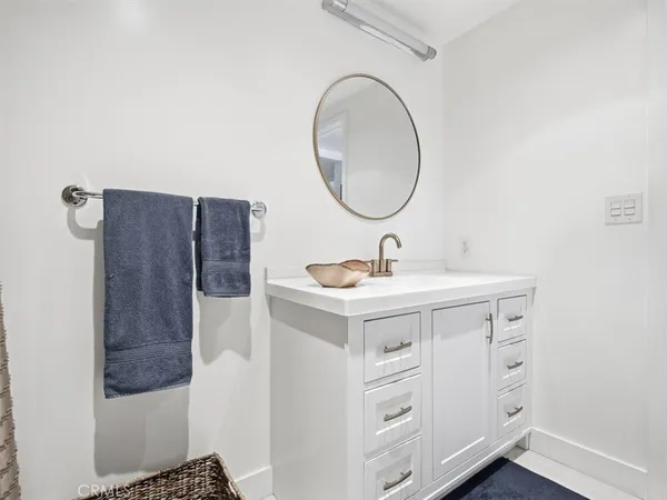 a bathroom with a sink vanity and a mirror