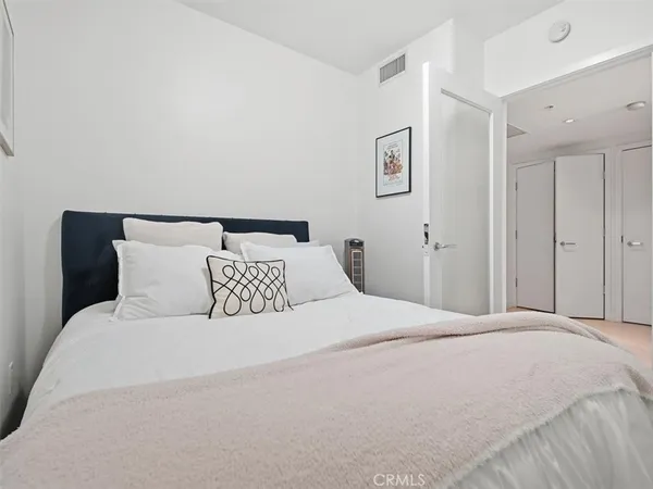 a large white bed in a white room