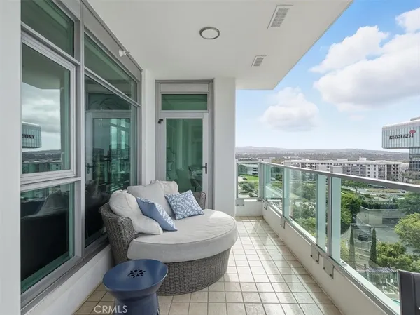 a view of a balcony with couch and wooden floor