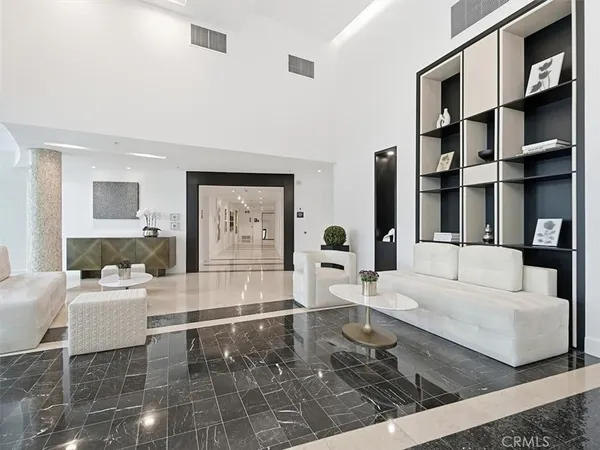 a living room with furniture a rug and white walls