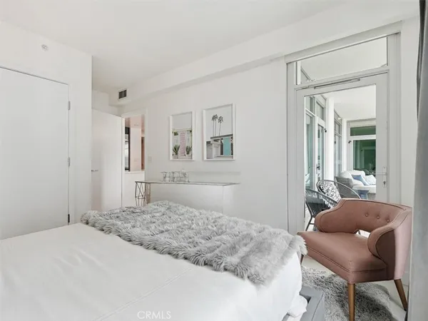 a bedroom with a bed and a chair