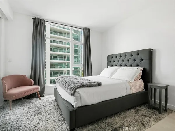 a bedroom with a bed and a couch