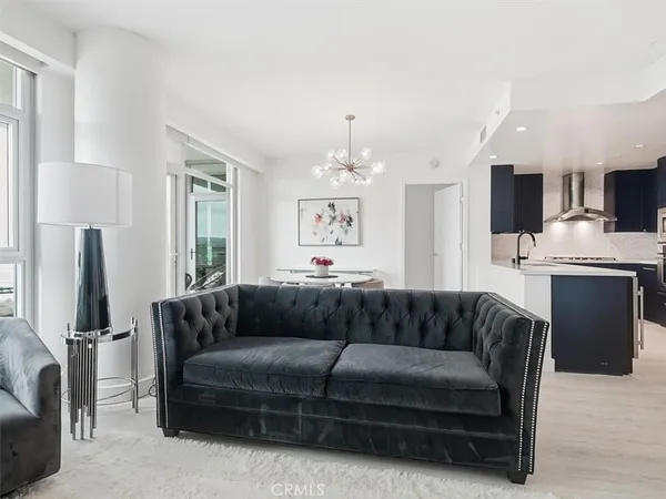 a living room with furniture a couch and a flat screen tv