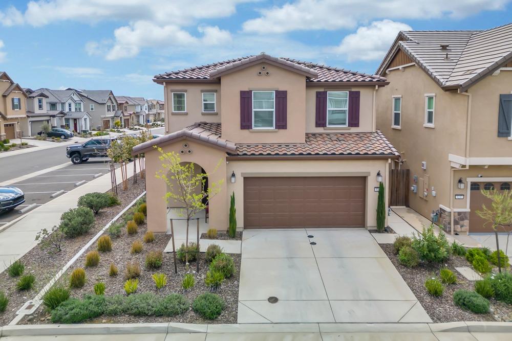 a front view of a house with garden