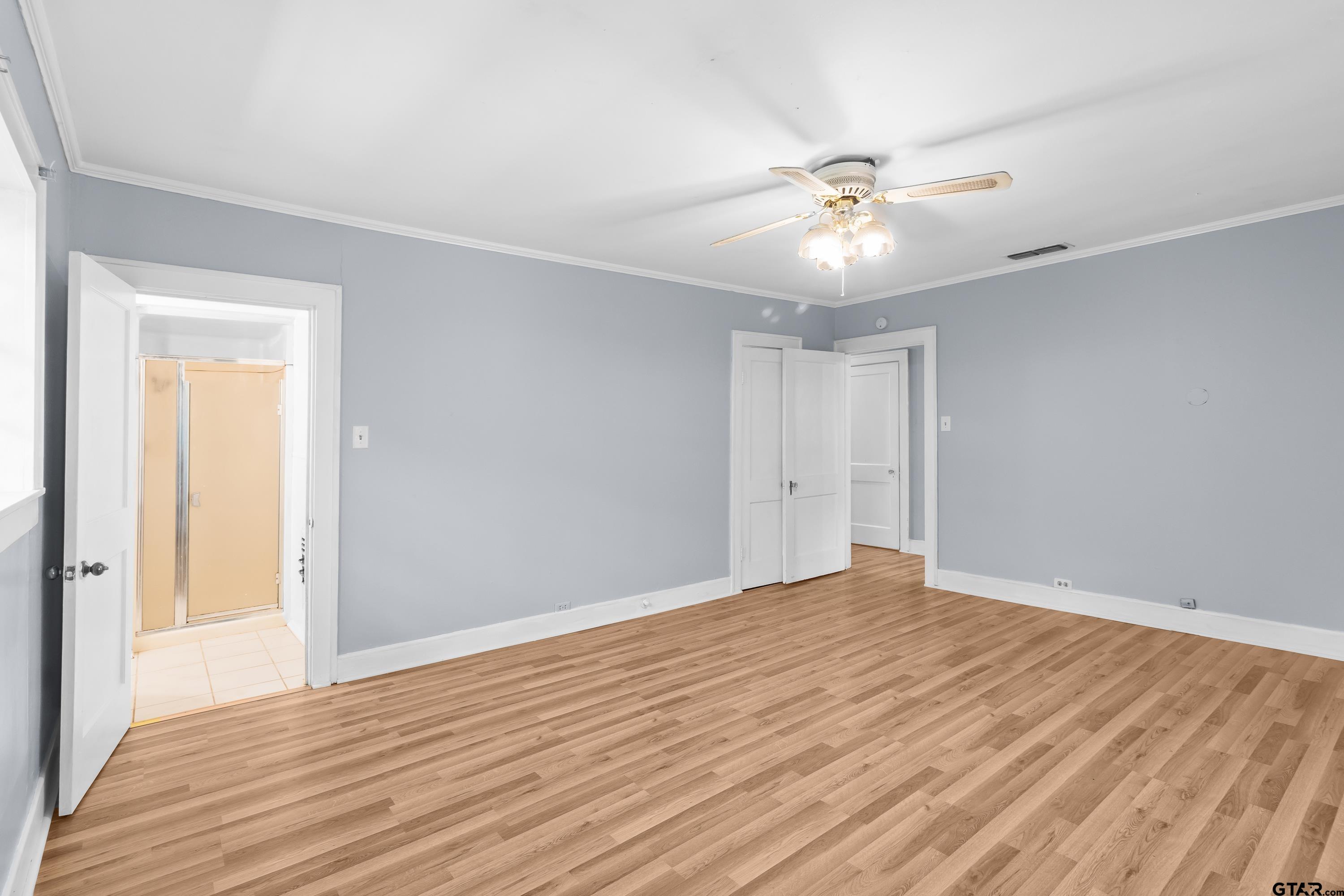 514 West Main Street Henderson, TX 75652 - Photo 16 of 35 a view of an empty room with wooden floor and a ceiling fan