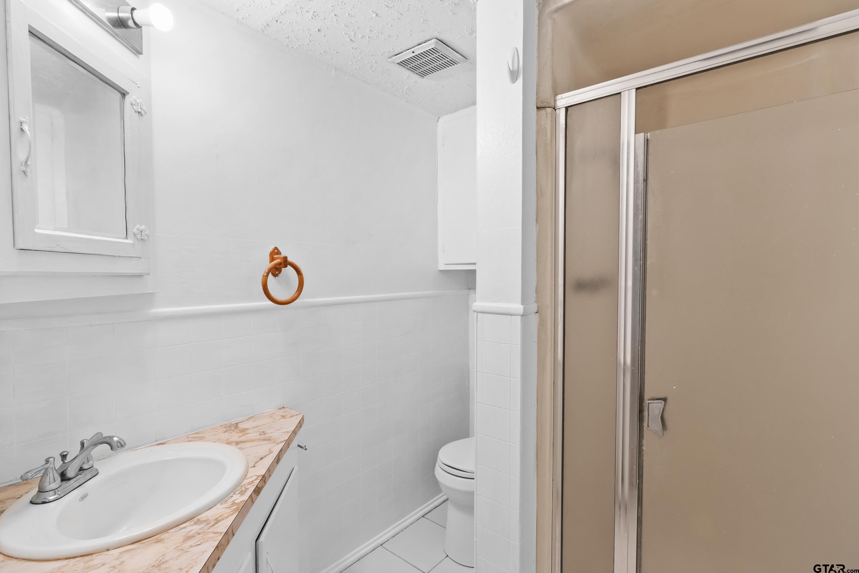 514 West Main Street Henderson, TX 75652 - Photo 17 of 35 a bathroom with a sink toilet and shower