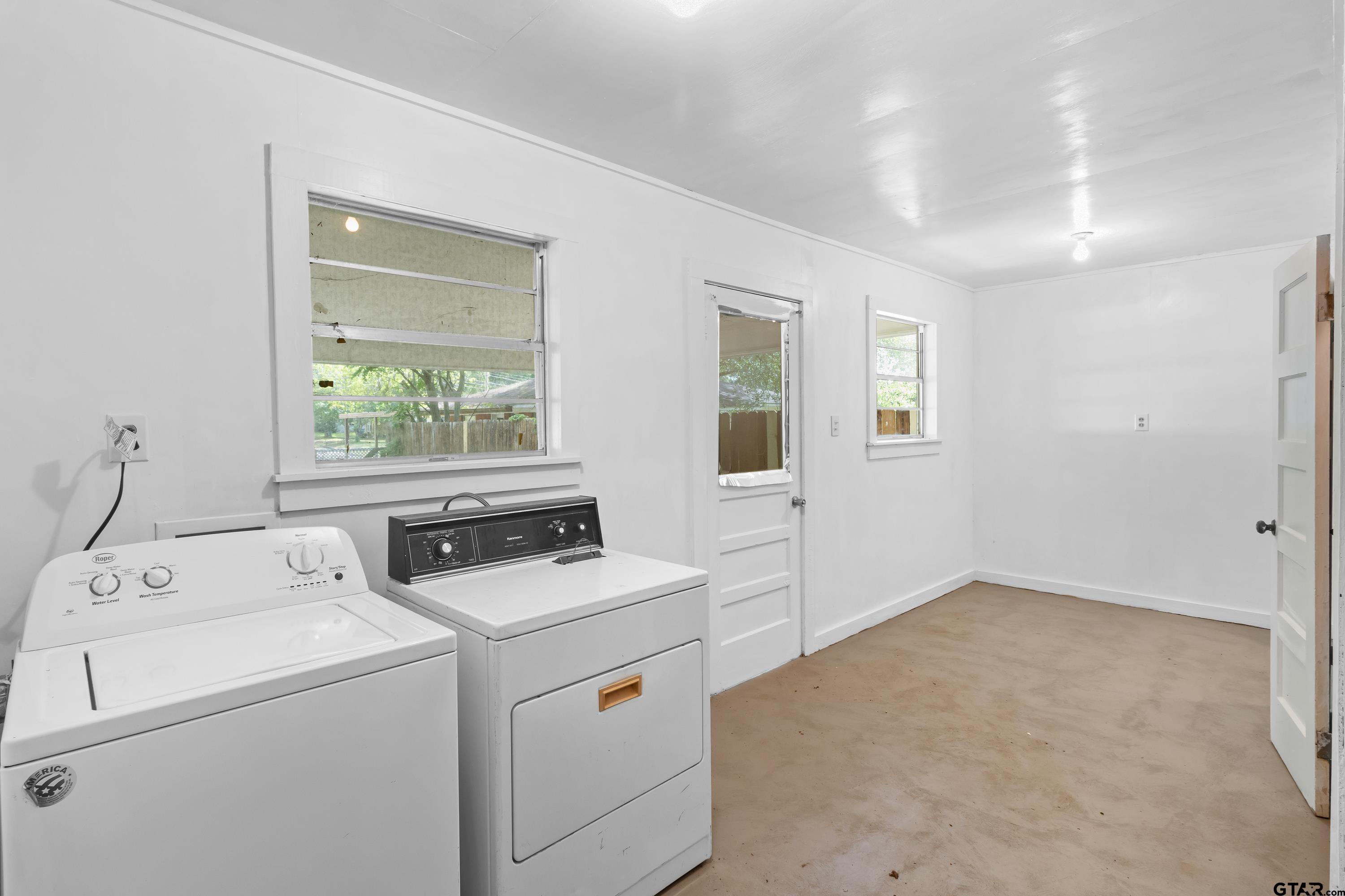 514 West Main Street Henderson, TX 75652 - Photo 25 of 35 a view of storage and utility room with washer and dryer