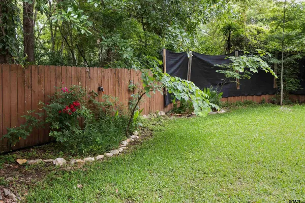 a view of garden with plants and trees