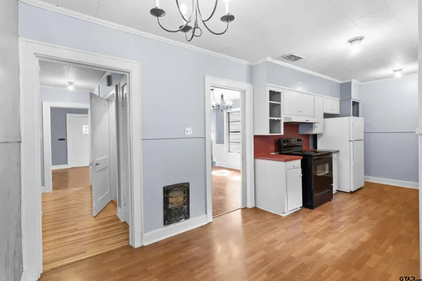 a view of kitchen with stainless steel appliances refrigerator stove microwave and cabinets