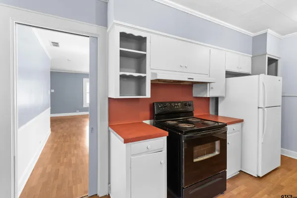 a kitchen with stainless steel appliances granite countertop a refrigerator and a stove