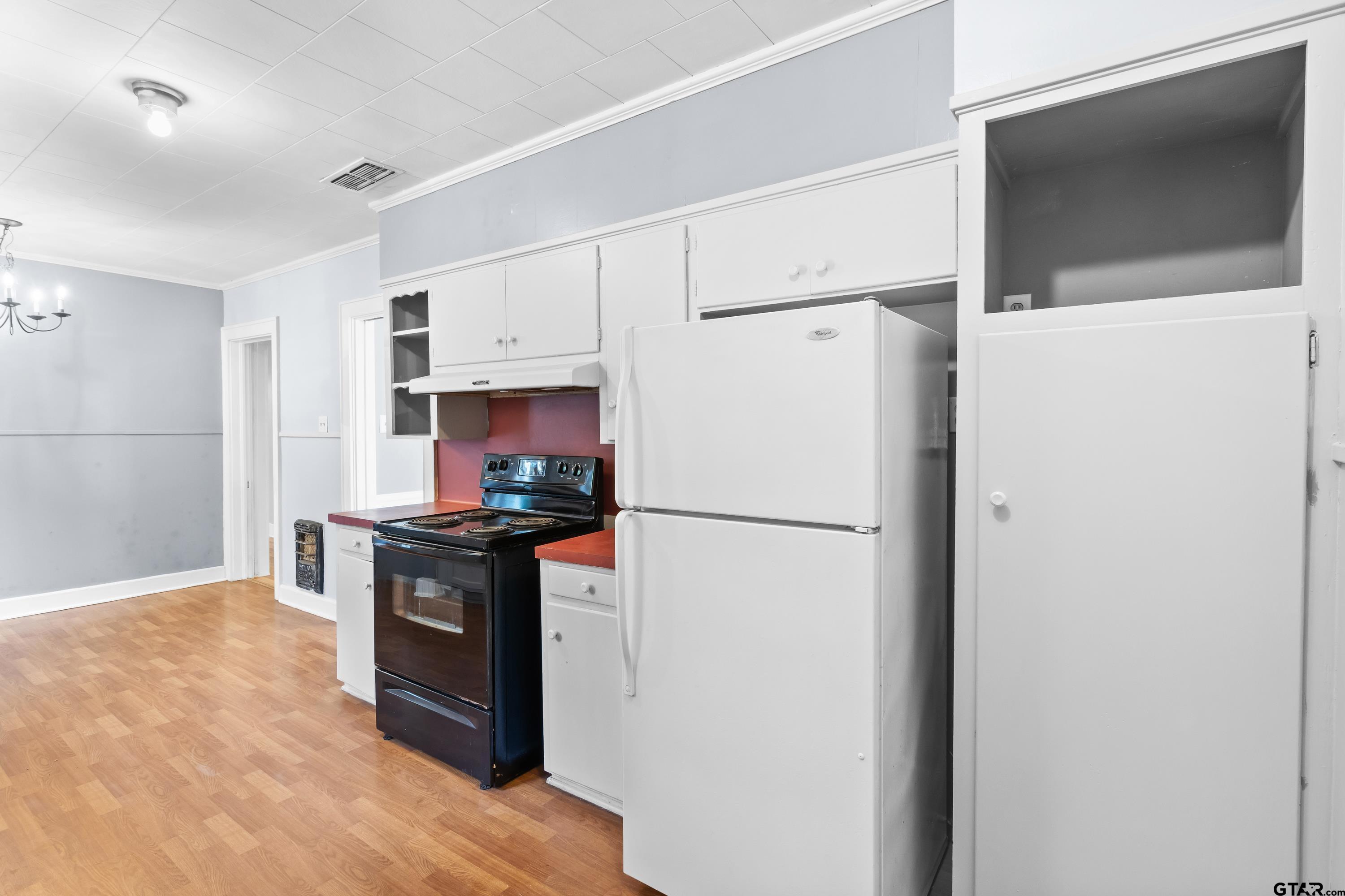 514 West Main Street Henderson, TX 75652 - Photo 10 of 35 a kitchen with stainless steel appliances a refrigerator sink and stove