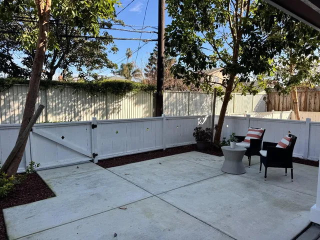 a view of a patio with table and chairs and potted plants