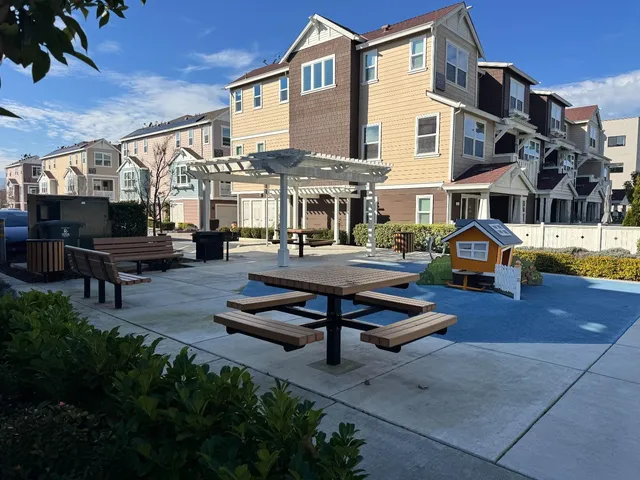 a front view of a house with swimming pool and sitting space