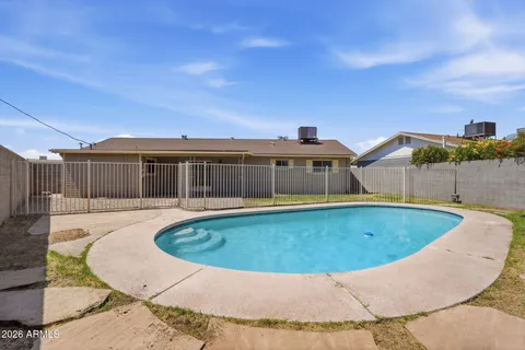 a view of a swimming pool with a yard