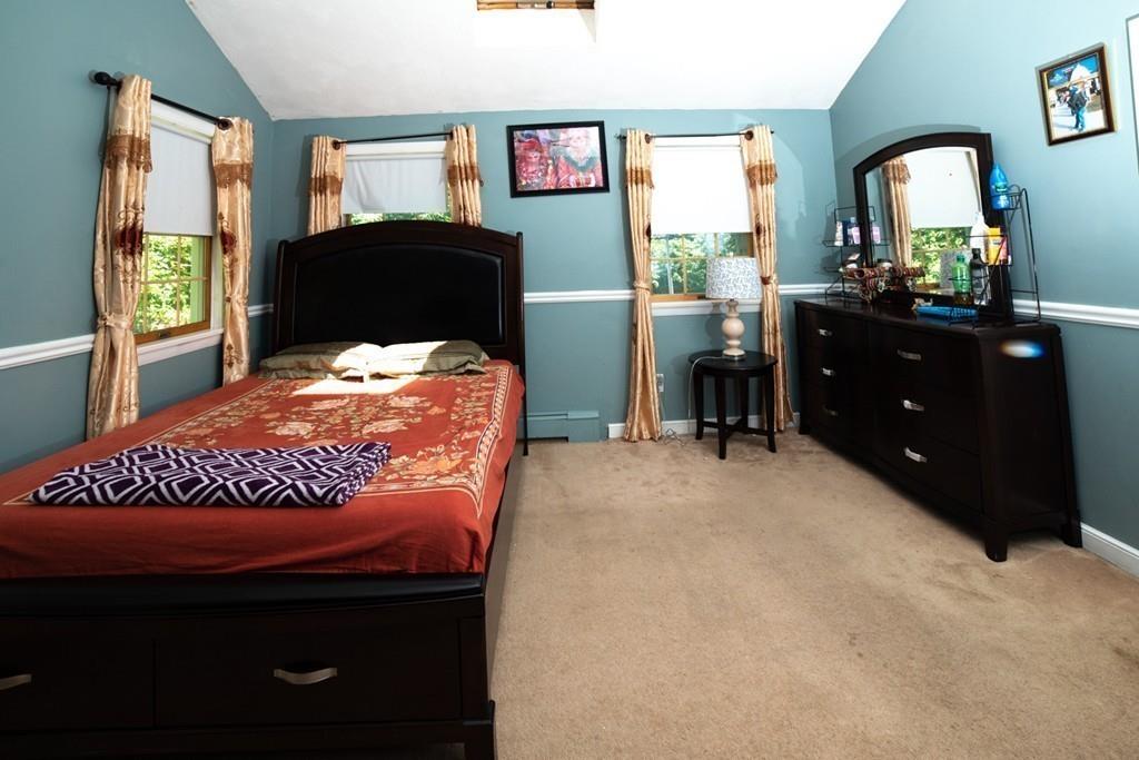 46 Dover Road Millis, MA 02054 - Photo 14 of 28 a bed sitting in a bedroom next to a window