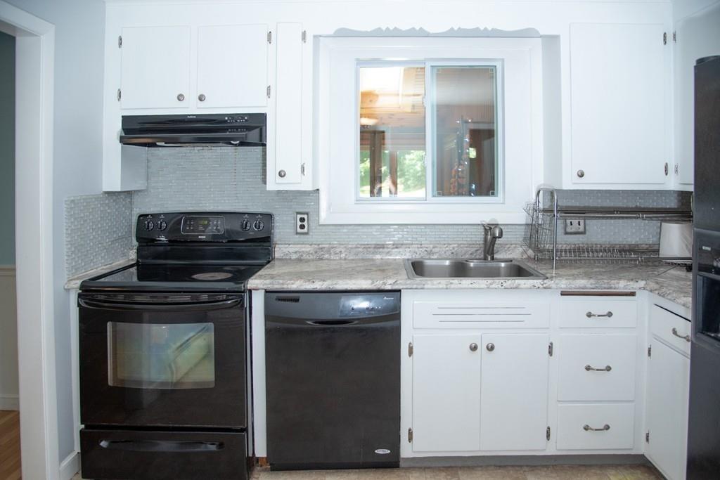 46 Dover Road Millis, MA 02054 - Photo 18 of 28 a kitchen with granite countertop a stove sink and cabinets