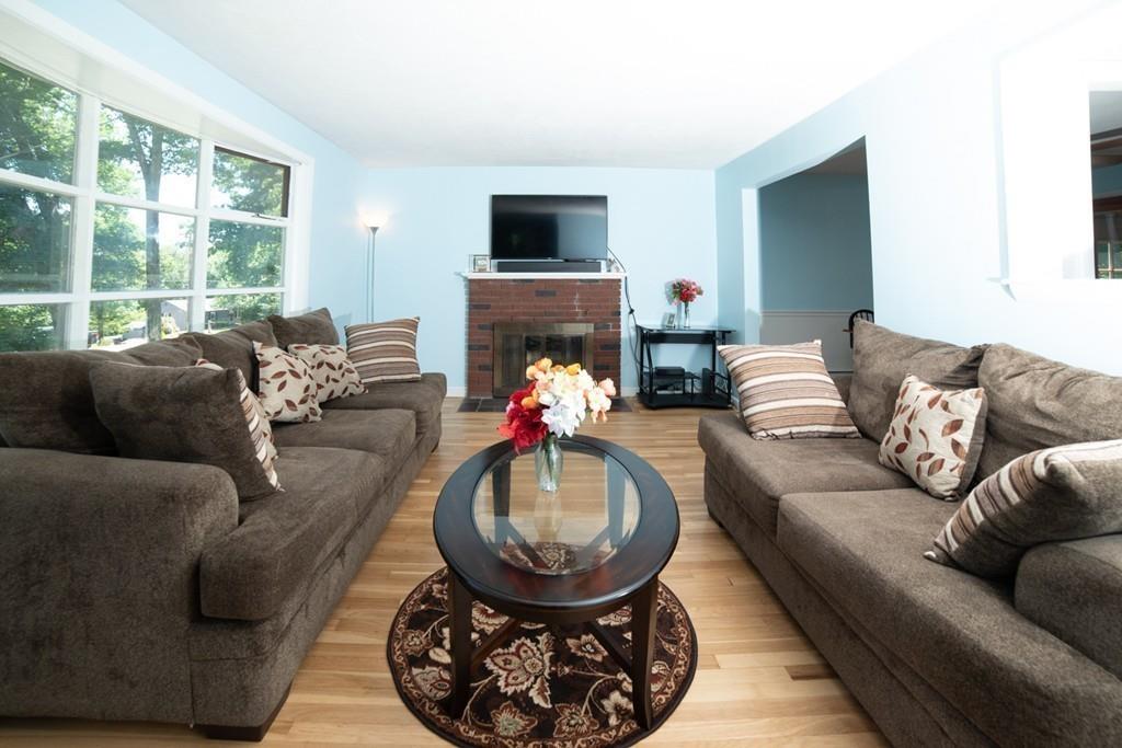 46 Dover Road Millis, MA 02054 - Photo 20 of 28 a living room with furniture a fireplace and a flat screen tv