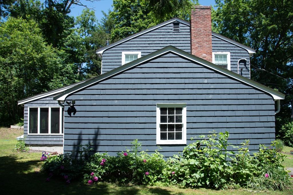 46 Dover Road Millis, MA 02054 - Photo 5 of 28 a house that has a large window and flower plants