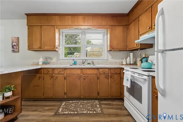 a kitchen with a sink cabinets and window