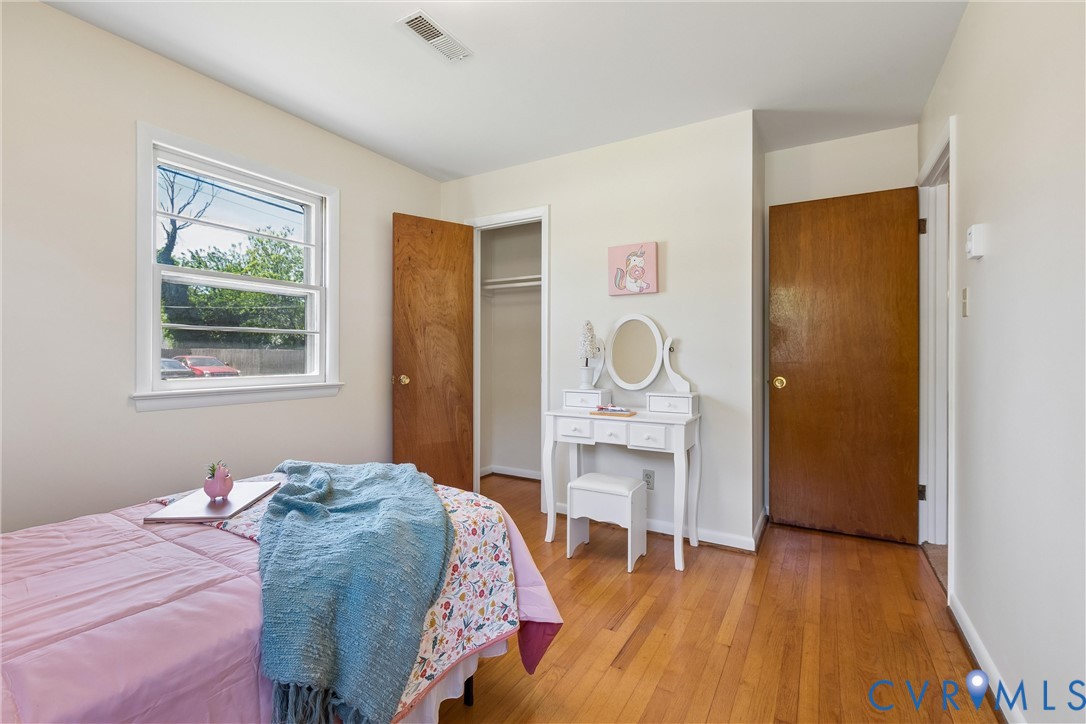803 Belfast Avenue Hampton, VA 23661 - Photo 22 of 34 a bedroom with a bed and wooden floor
