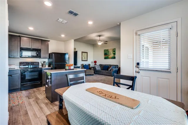 a kitchen with stainless steel appliances granite countertop a sink refrigerator and microwave