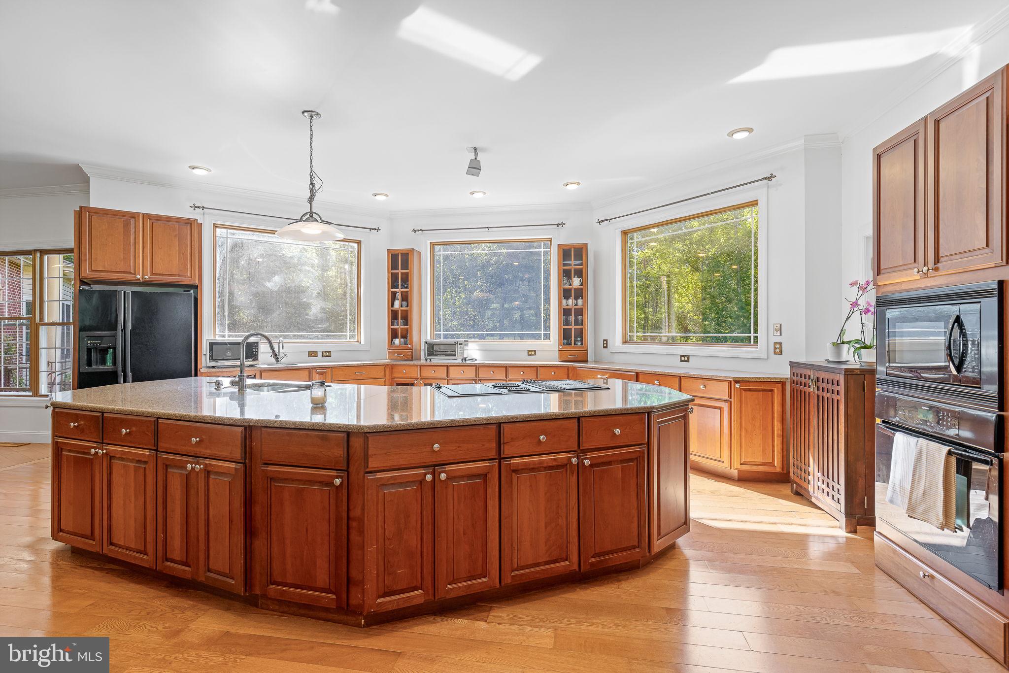 895 Stefaniga Road Stafford, VA 22556 - Photo 15 of 41 a kitchen with kitchen island granite countertop a sink and wooden cabinets