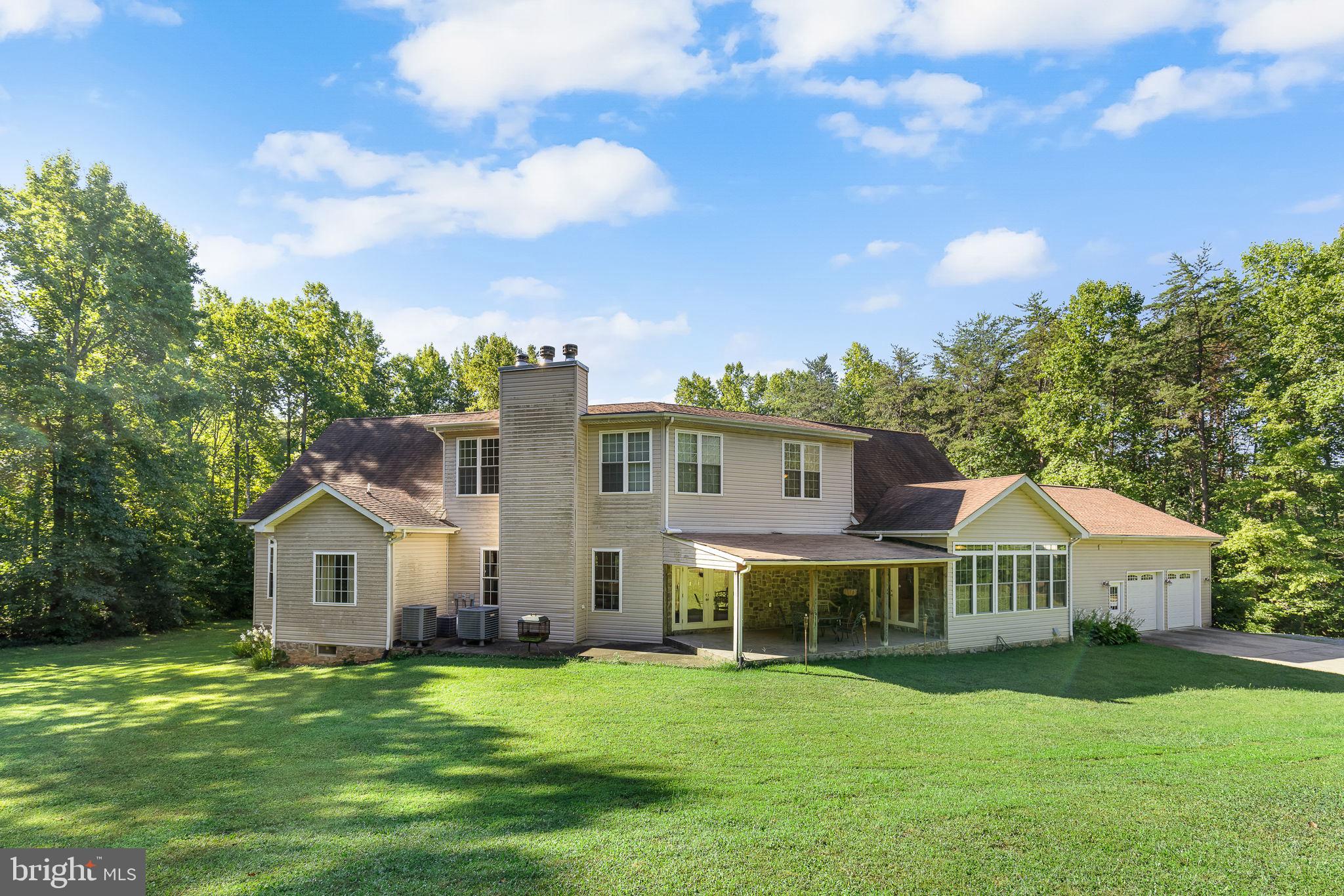 895 Stefaniga Road Stafford, VA 22556 - Photo 37 of 41 a front view of a house with a garden and trees