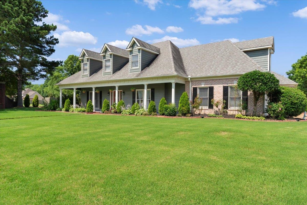 1675 John Ridge Drive Collierville, TN 38017 - Photo 2 of 39 Cape cod house featuring a front yard, a shingled roof, a porch, and brick siding