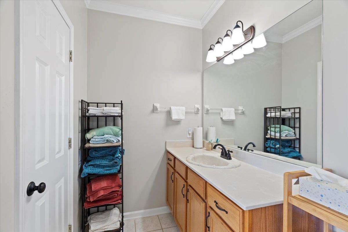 1675 John Ridge Drive Collierville, TN 38017 - Photo 21 of 39 Bathroom featuring vanity, ornamental molding, baseboards, and tile patterned flooring