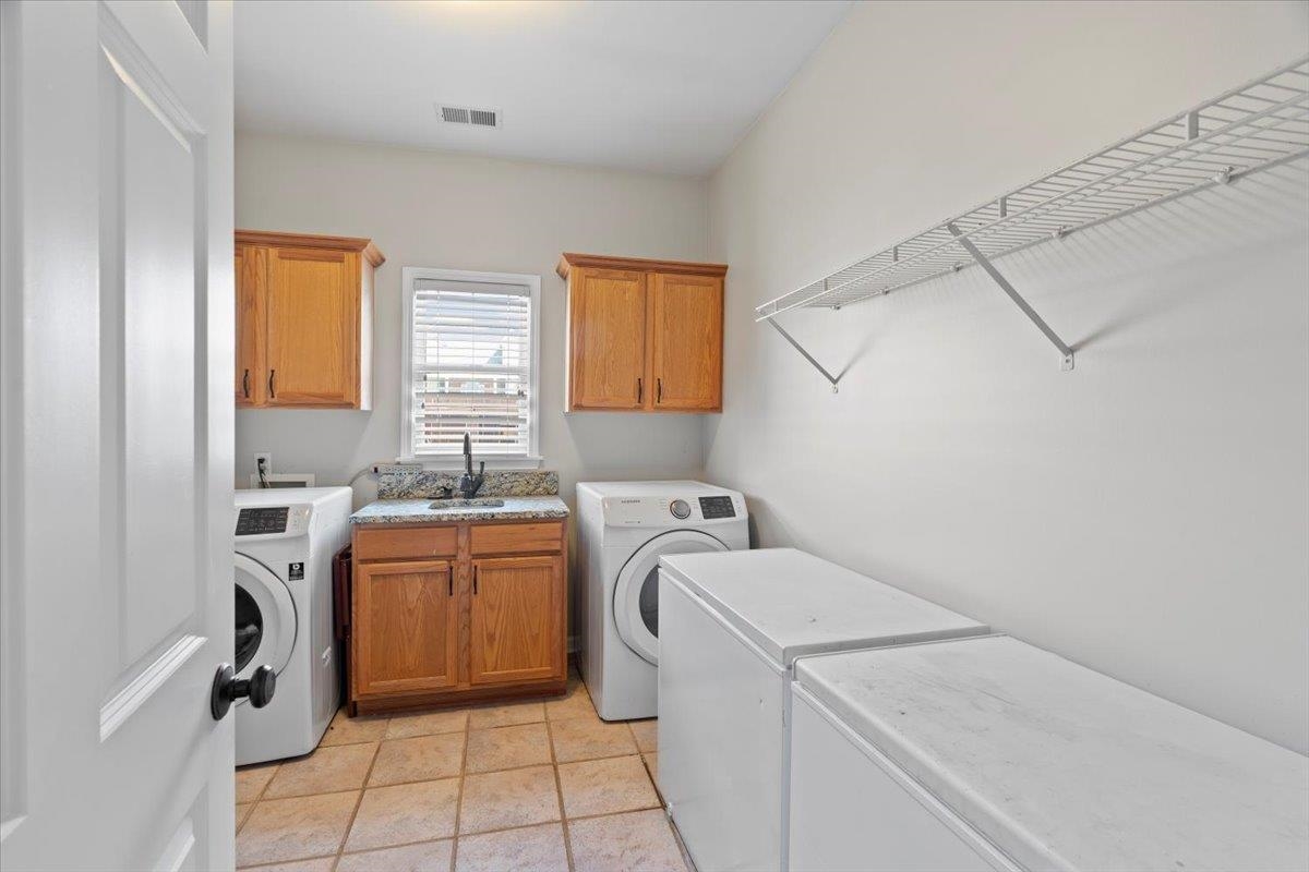 1675 John Ridge Drive Collierville, TN 38017 - Photo 23 of 39 Washroom with cabinet space and independent washer and dryer